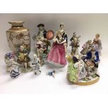 A box of ceramics comprising mainly figurines.
