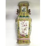 A tall hexagonal famille juan vase with birds and