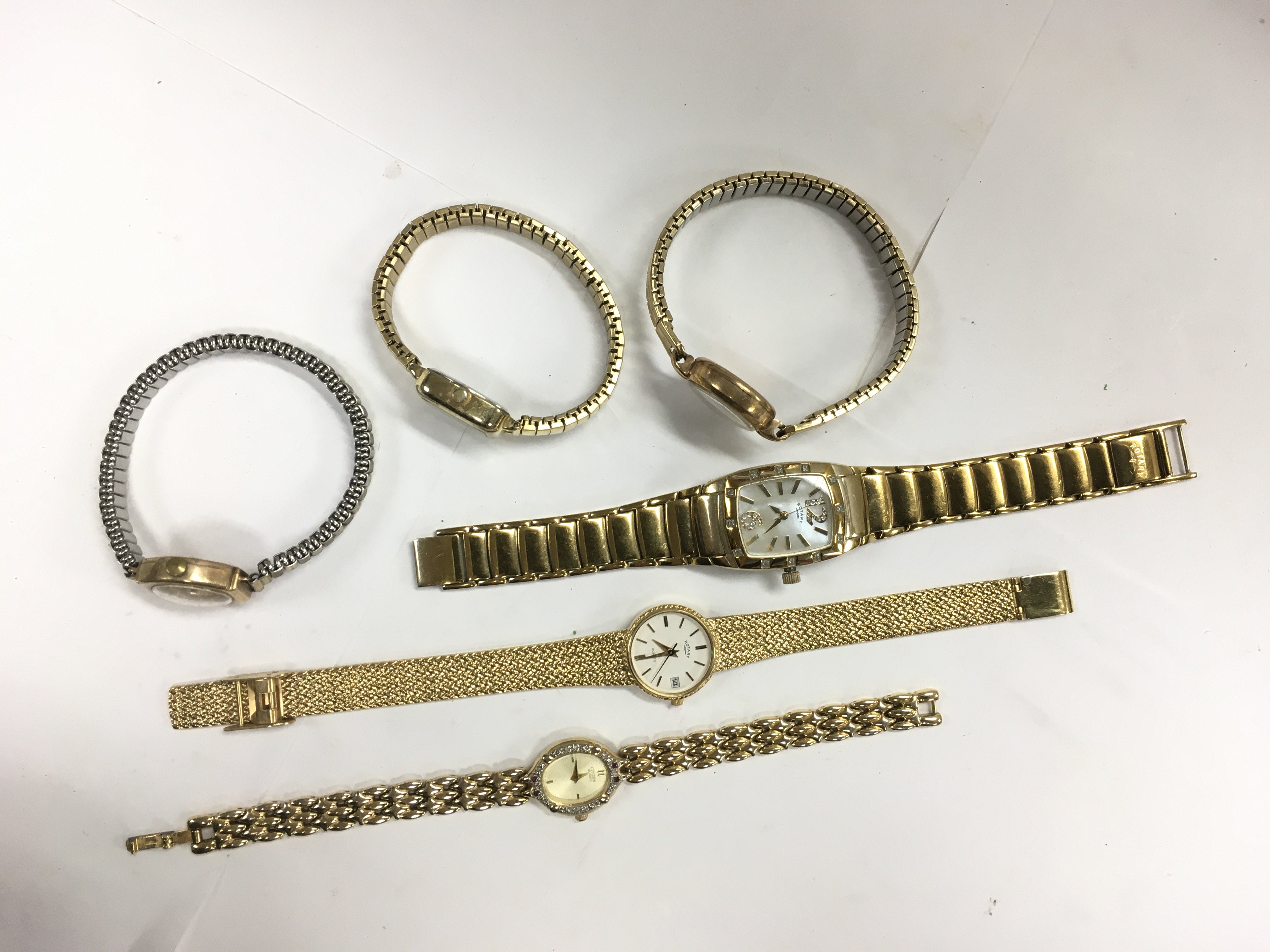 Six gold tone ladies watches.