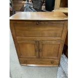 A Blonde Ercol Windsor serving cabinet. 97 x 82 x