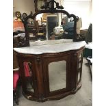 A late Victorian inlaid walnut chiffonier with a mirrored back with a marble top above mirrored