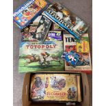 A box of mixed board games.