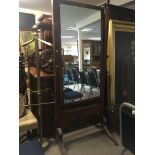 A Regency style mahogany cheval mirror with a rectangular mirror on square supports.
