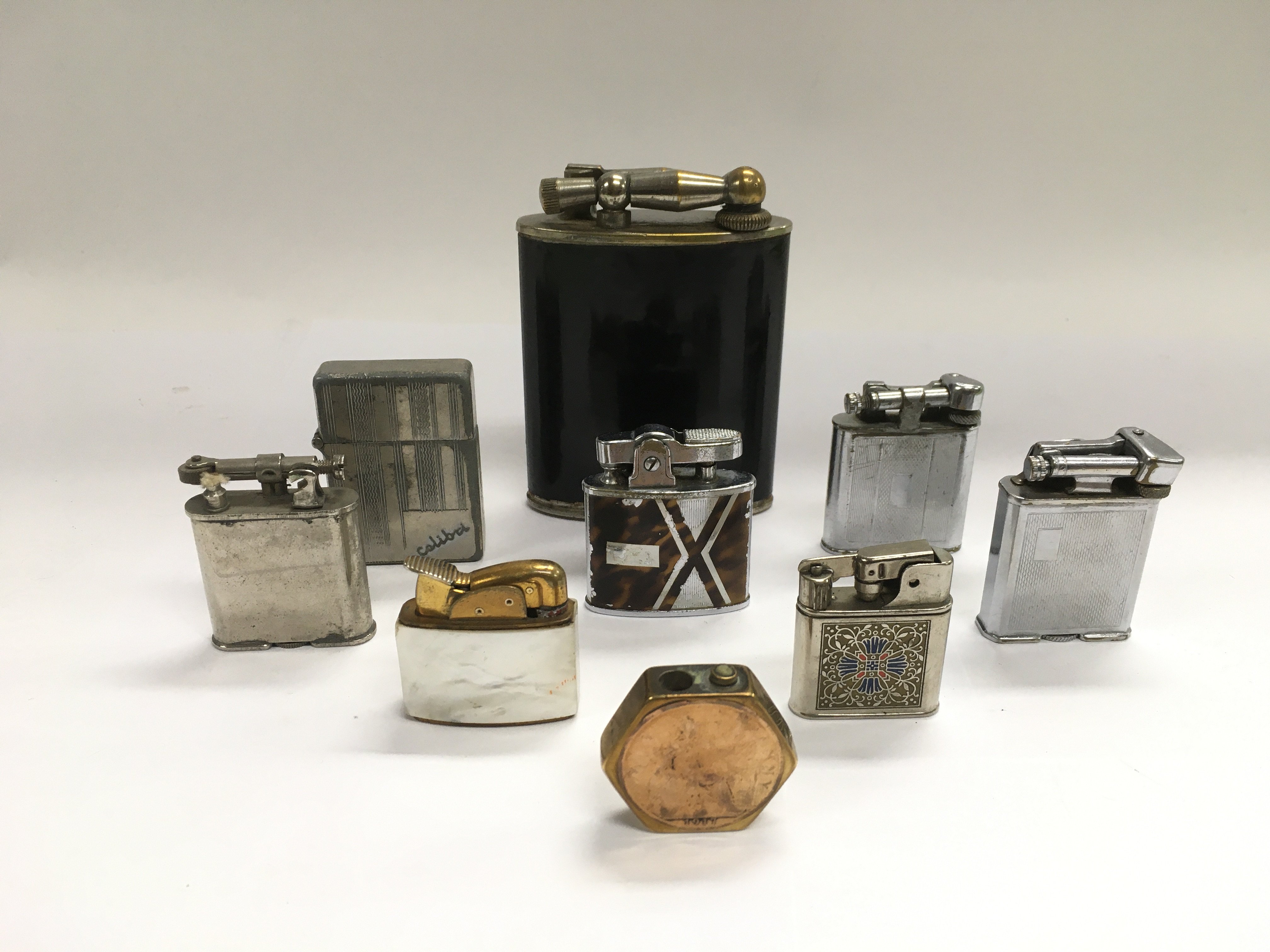 A collection of vintage petrol lighters.