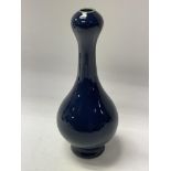 A small Chinese porcelain dark blue glazed vase wi