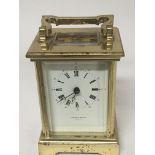 A brass carriage clock by Taylor & Bligh England.