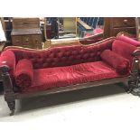 A late Regency mahogany sofa with a shaped back sc