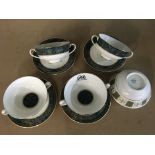 Four Royal Doulton soup bowls and saucers in the C