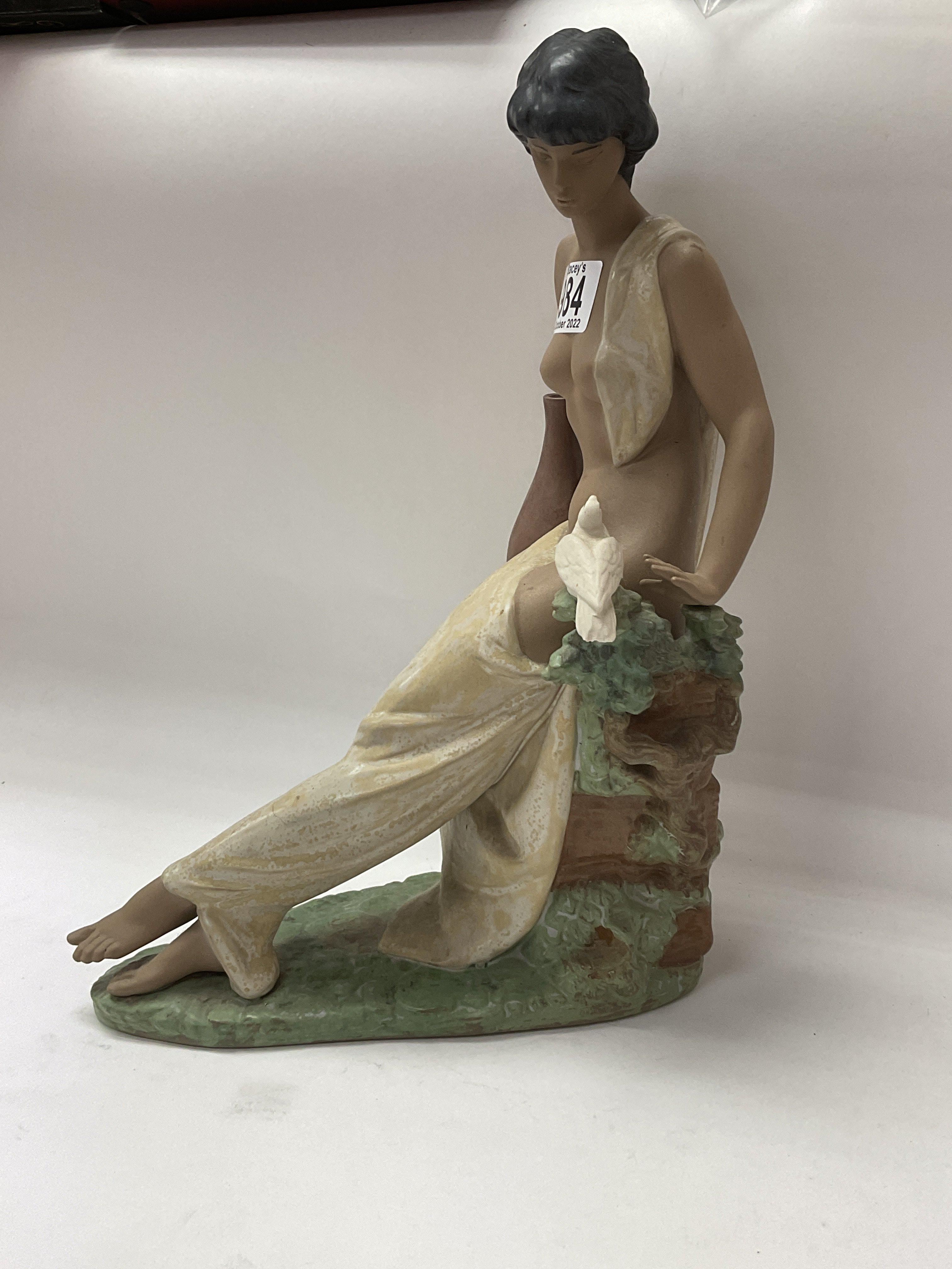 A Lladro terracotta finish figure of a maiden. 34c