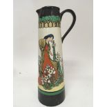 An Art Deco Art pottery jug decorated with a figur