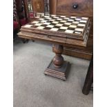 A chess table with a polished stone top above two