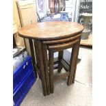 An oak nest of three tables.