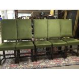 A set of five oak dining chairs with green upholst