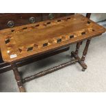A Victorian stretcher base walnut table with a par