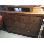 A modern Teak chest of drawers fitted with three graduating rows of drawers length 106cm