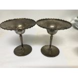 A pair of silver dishes the turned stem on circula