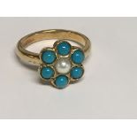 A 9 ct gold ring inset with central pearl surround