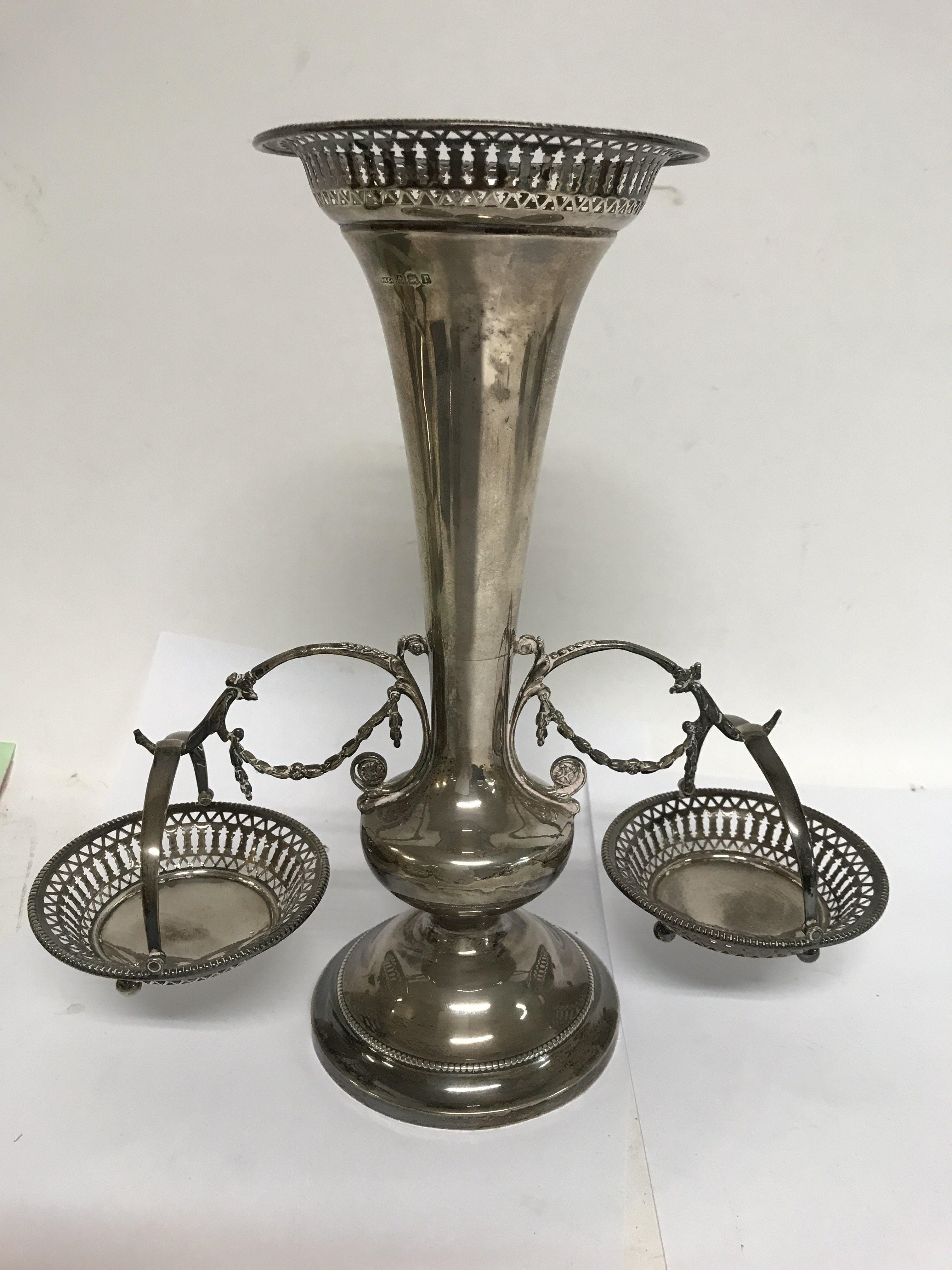A silver trumpet vase with applied hanging baskets