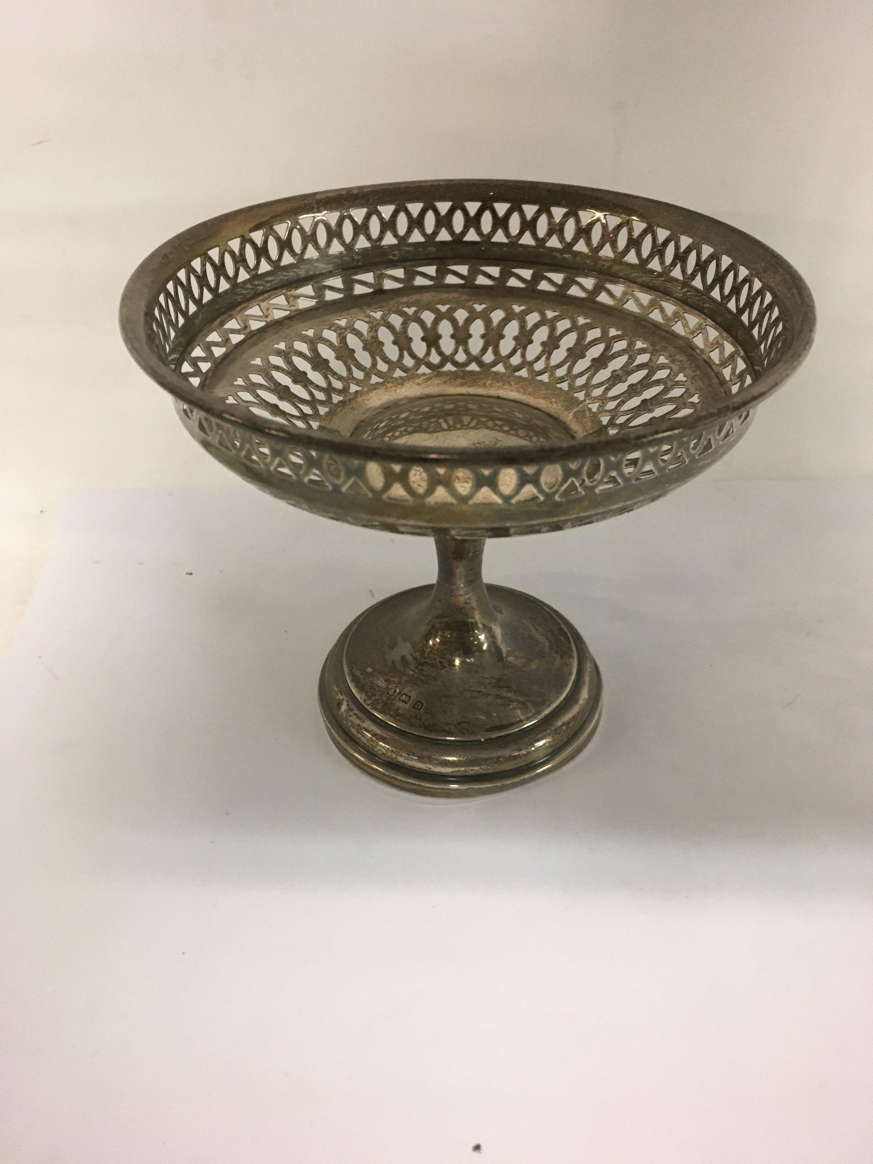 A small silver basket the tapering stem on a circular base Birmingham hallmarks. 128 grams