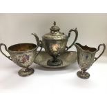 A Victorian four piece silver plated tea service with ornate decoration.