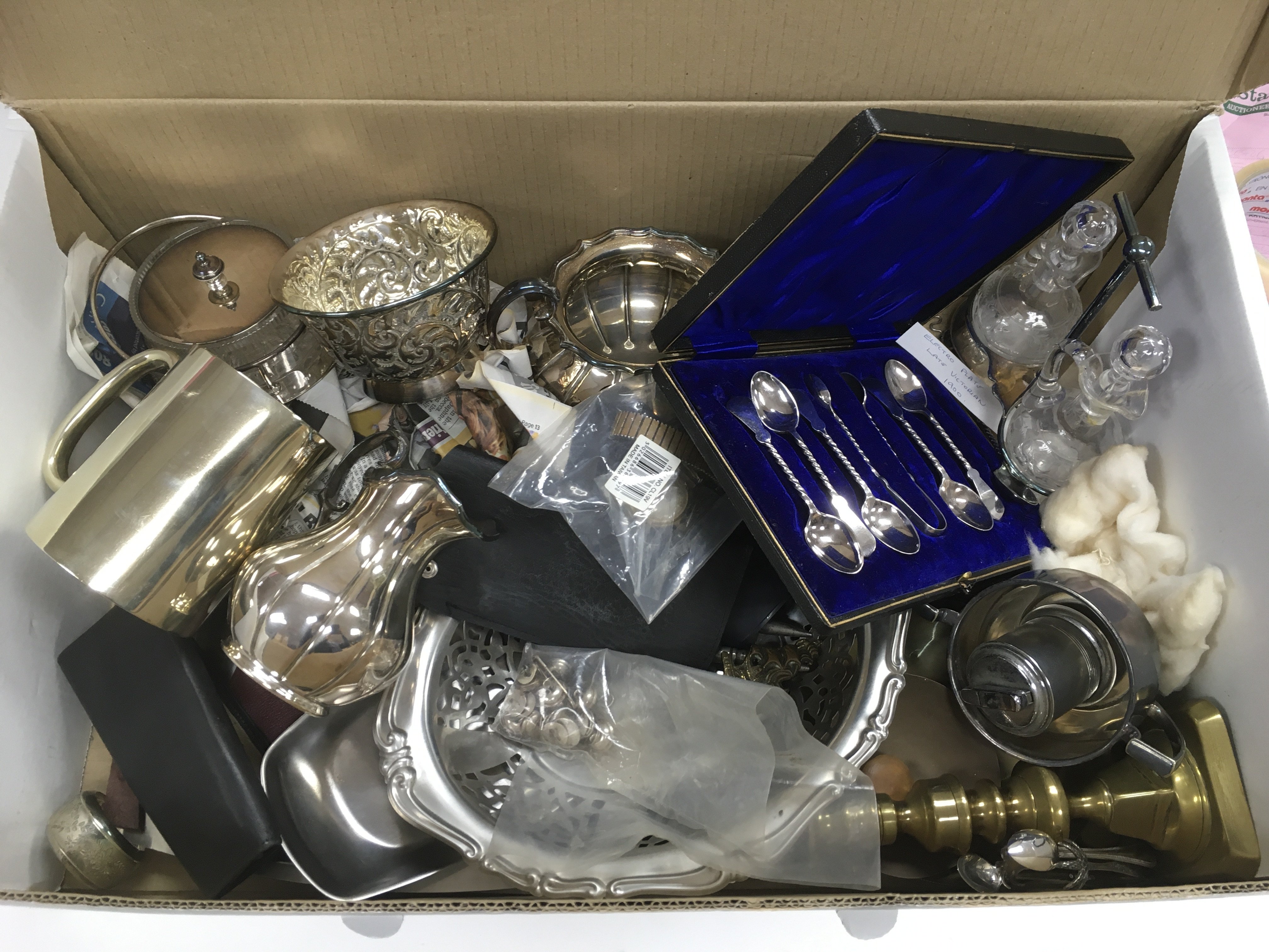 A box containing a collection of silver plate and other items.NO RESERVE