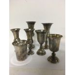A collection of seven kiddush cups and a 800 marked Israel cigarette case .