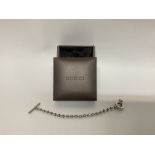 A silver Gucci bracelet with box and pouch