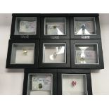 8 x loose gem stones in display cases some with CO