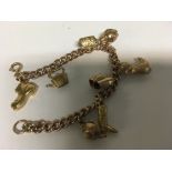 A 9 ct gold bracelet with attached charms . 22.5 g