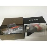A Chanel box and a Gucci box containing designer spare buttons and tags and other oddments (a lot)