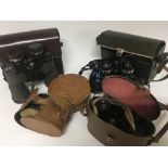 A collection of binoculars a cased pair of silver