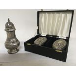 A silver sugar caster London hallmarks and a pair of cased silver brushes.