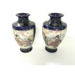Pair of Japanese vases with signed base. Height is approximately 6.5inches.