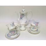 A Royal Albert Porcelain coffee service decorated with flowers. Four cups and saucers no obvious