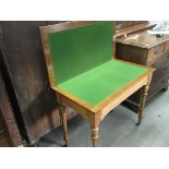 A carved golden oak late Victorian card table with a hinged top on turned and fluted legs. Length