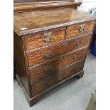 A George II style walnut chest of drawers fitted with two short and three long drawers on bracket