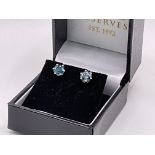 A pair of 14ct gold solitaire ear studs set with 1