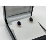 A pair of 18ct treated sapphire and diamond studs.