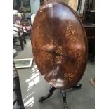 A Victorian inlaid walnut loo table the oval top on a turned column. Top width 105cm NO Reserve