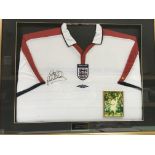 A framed and glazed England shirt signed by Michael Owen, approx 88cm x 71cm.