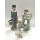 Three Lladro figures of boys and girls, tallest approx 22cm.