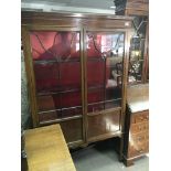 An Edwardian inlaid Mahogany display cabinet with a pair of three quarter glazed doors on square