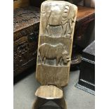 A carved hardwood African tribal birthing chair. C