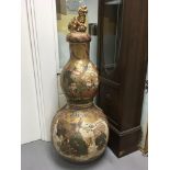 A large and impressive satsuma double gourd vase the detached lid with raised temple dog , decorated