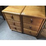 A pair of modern teak chests of drawers each with three drawers