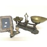 A modern silver photo frame a silver plated condiment set and a set of brass and cast metal beam