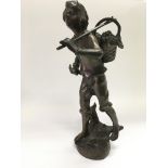 A bronze figure of a farmworker carrying a basket laden with berries, approx height 34.5cm.