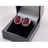 A pair of 18ct white gold ruby and diamond cluster