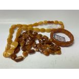 3 Amber bead jewellery items.