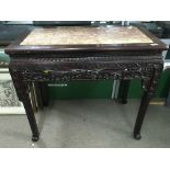 A Chinese side table inset with Rose Marble, with carved and scrolled folate decoration. 87cm x 46cm